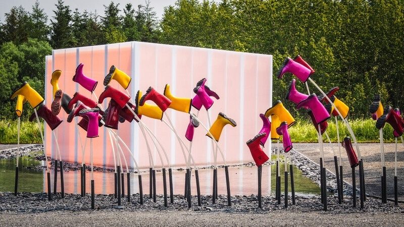 Colorful boot-like sculptures arranged in an outdoor public installation