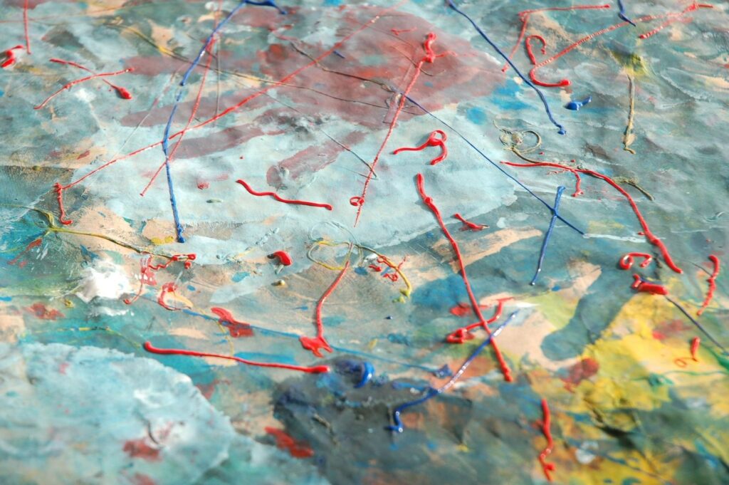 Abstract mixed-media surface with raised red and blue lines