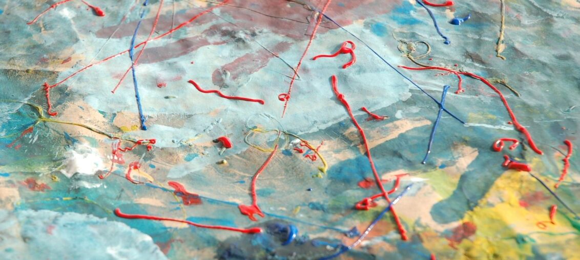 Abstract mixed-media surface with raised red and blue lines
